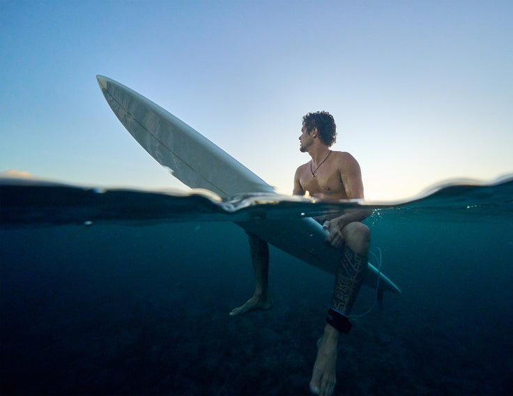 Sit on a surfboard